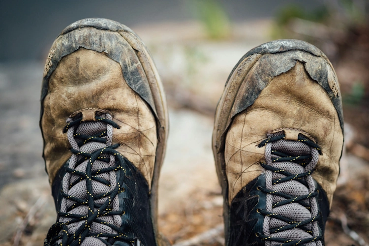 Close-up of hiking boots on rocky mountain trail